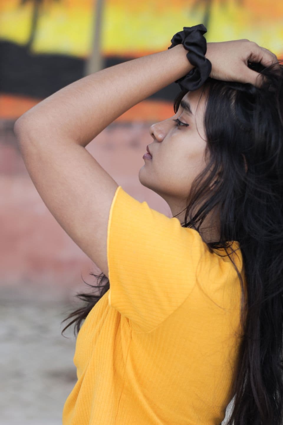 Side view showing a South Asian model's long dark hair